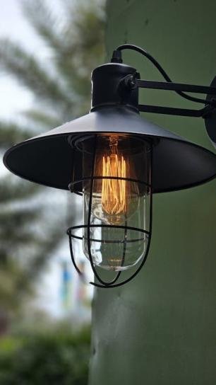 Close-up of a weatherproof outdoor light fixture with sealed wiring and protective housing.