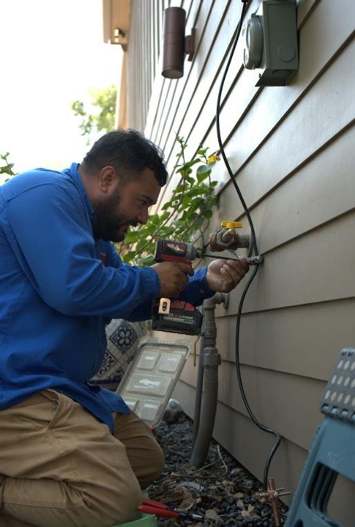 Electrician installing an exterior electrical connection on a home
