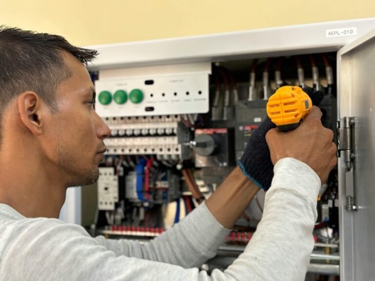 electrician inspecting a commercial electrical panel for maintenance and safety checks