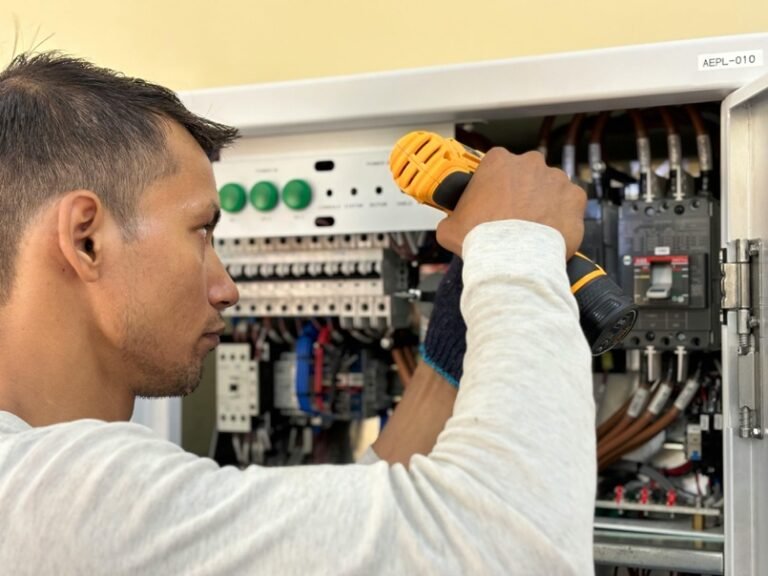 electrician inspecting residential wiring and outlets during a code compliance check
