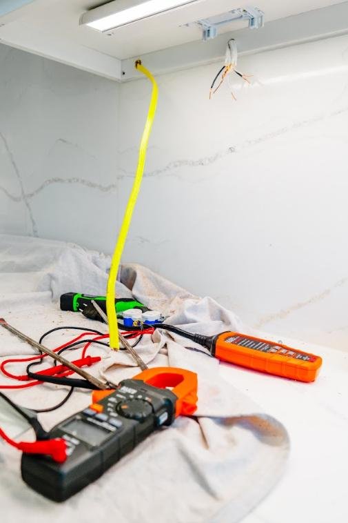 emergency-electrical-tools-work-area Electrical testing tools and wiring prepared for repair