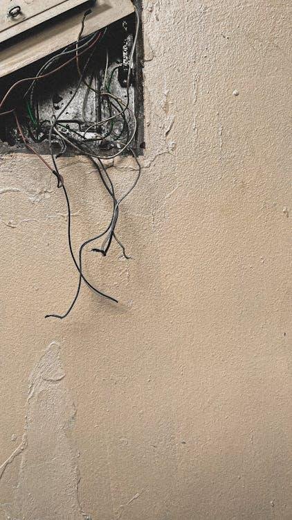 An older home electrical panel with aging breakers and exposed wiring