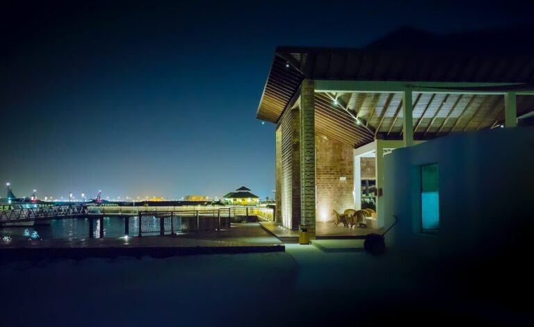 Contemporary waterfront property illuminated with energy-efficient LED exterior lighting at night