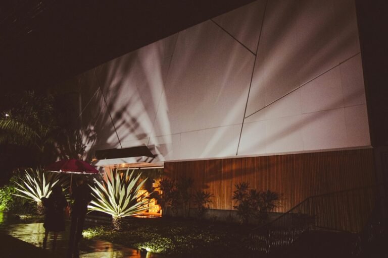 modern home exterior with LED landscape lighting at night