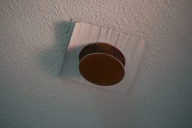 Ceiling mounted smoke alarm installed for fire detection.
